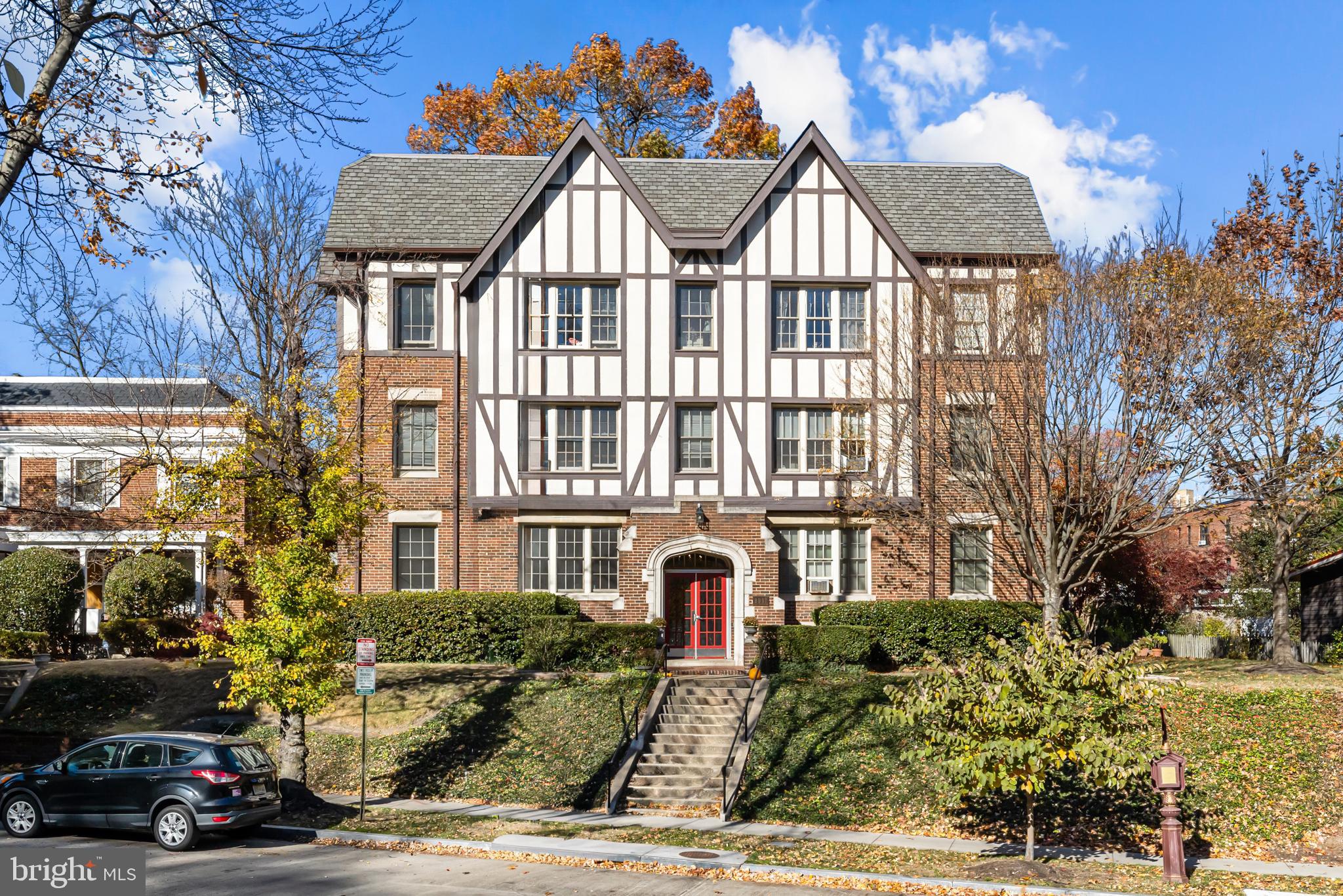 3001 Porter Street Northwest, Unit 100 Washington, DC 20008 - Photo 1 of 22 a view of a car parked in front of a brick house