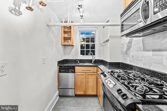 a kitchen with stove and cabinets