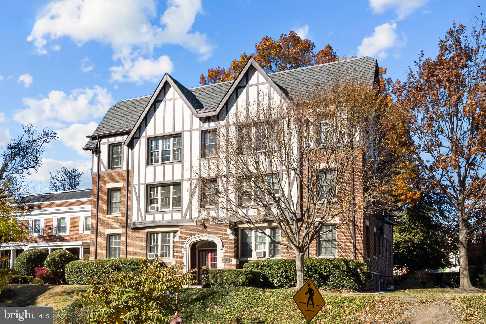 3001 Porter Street Northwest, Unit 100 Washington, DC 20008 - Photo 21 of 22 a front view of a residential apartment building with a yard