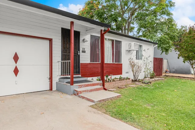 a backyard of a house with table and chairs
