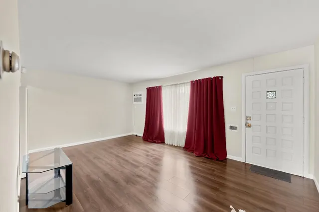 a view of a room with wooden floor and a chair