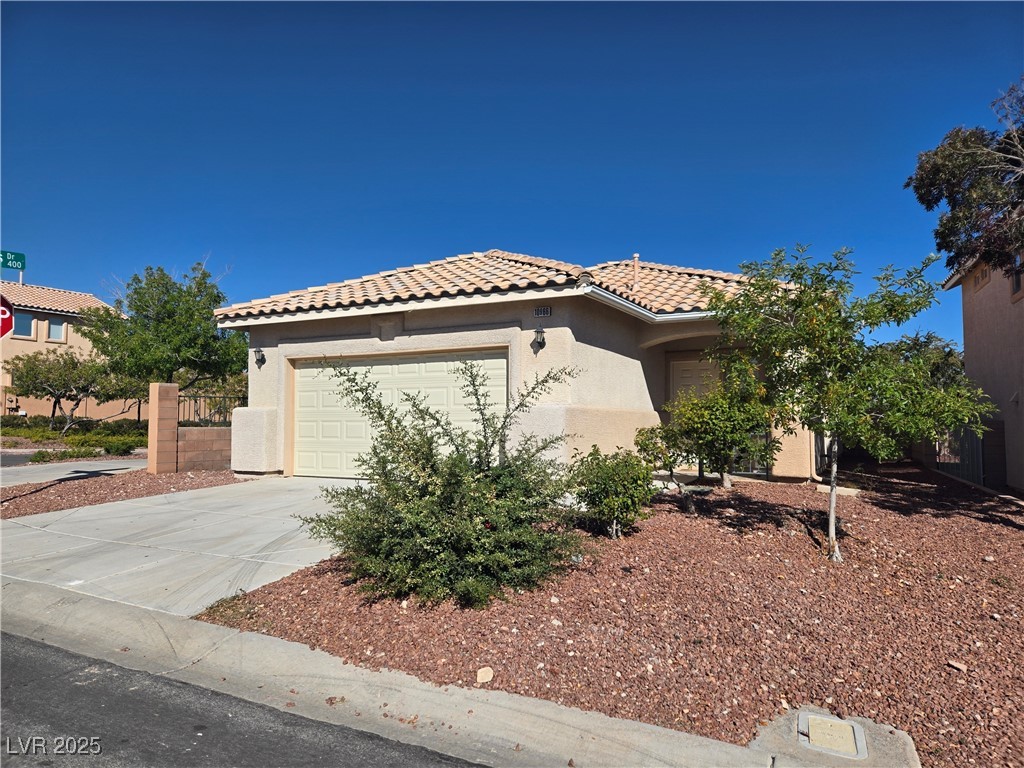 10966 Sutter Hills Avenue Las Vegas, NV 89144 - Photo 1 of 18 Mediterranean / spanish house with stucco siding, driveway, a garage, and a tile roof