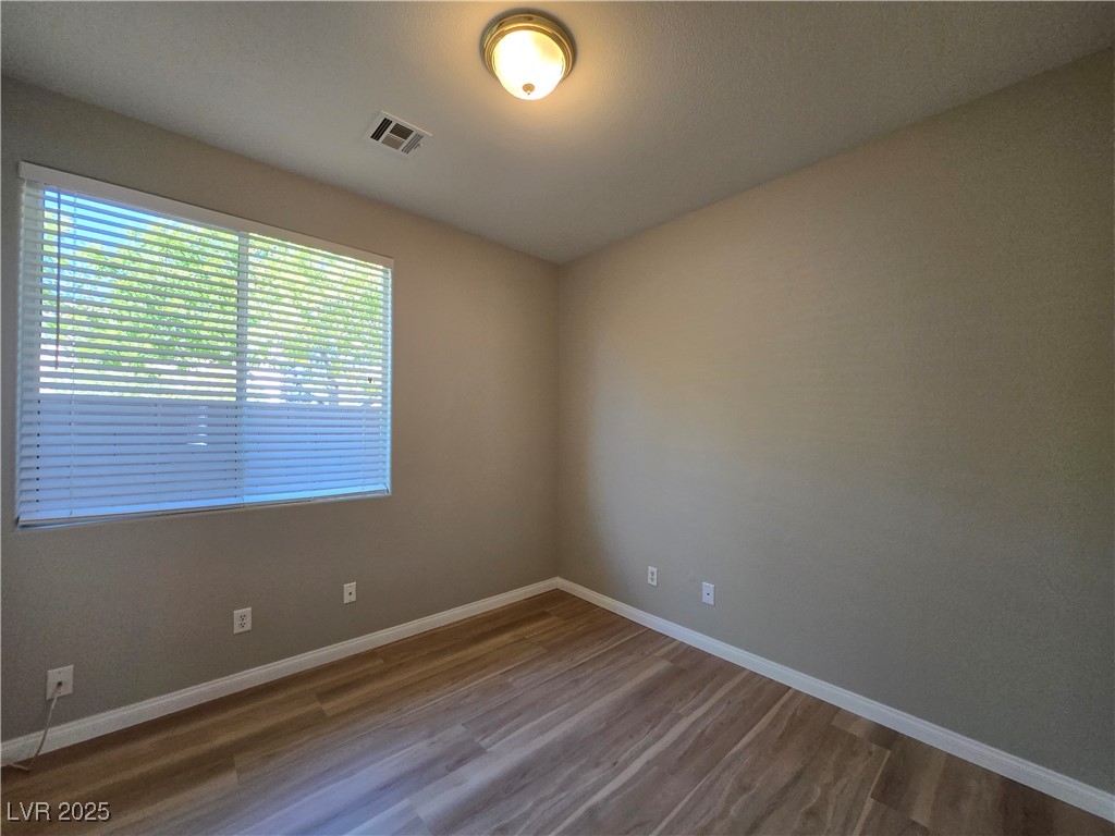 10966 Sutter Hills Avenue Las Vegas, NV 89144 - Photo 12 of 18 Empty room with dark wood-type flooring