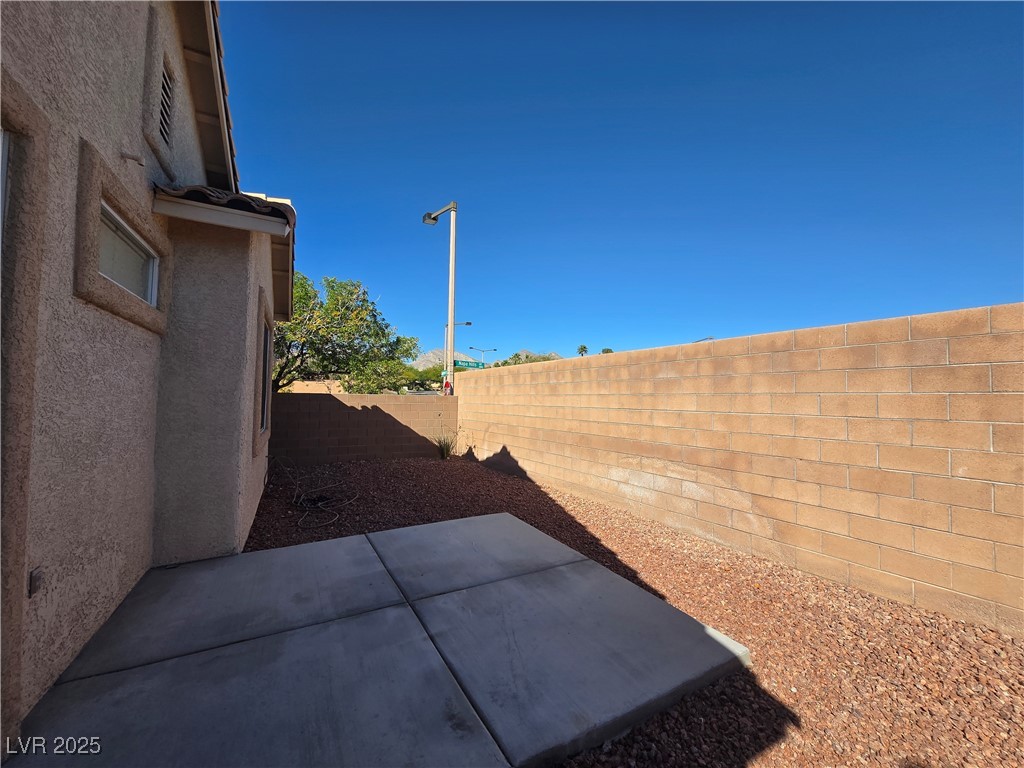 10966 Sutter Hills Avenue Las Vegas, NV 89144 - Photo 18 of 18 Fenced backyard featuring a patio area