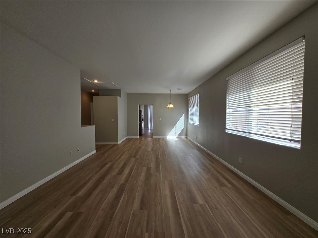 10966 Sutter Hills Avenue Las Vegas, NV 89144 - Photo 4 of 18 Unfurnished living room with baseboards and dark wood-type flooring