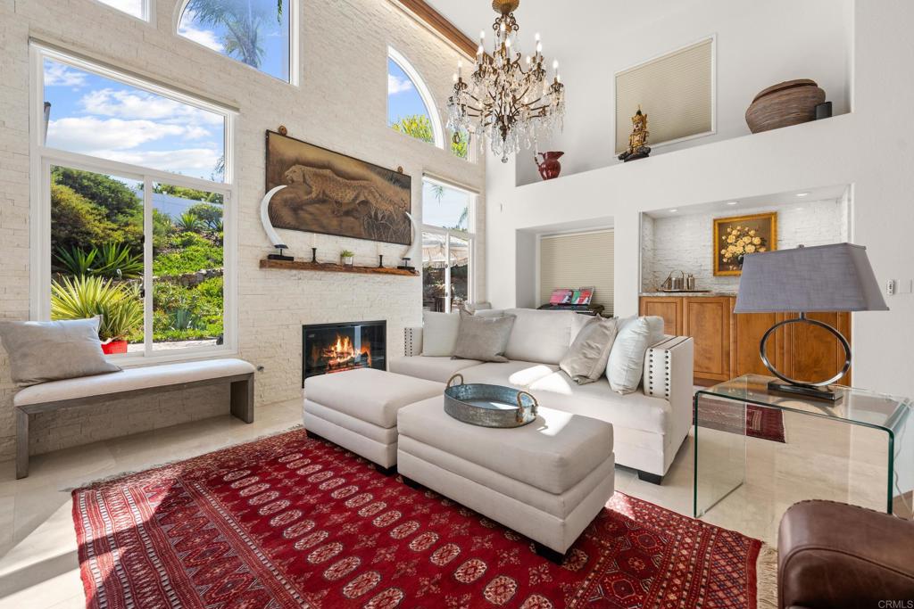 3427 Bumann Road Encinitas, CA 92024 - Photo 11 of 37 a living room with furniture a fireplace and a large window