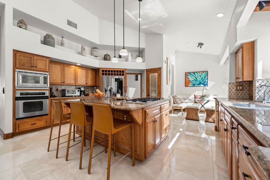3427 Bumann Road Encinitas, CA 92024 - Photo 15 of 37 a large kitchen with lots of counter top space and stainless steel appliances
