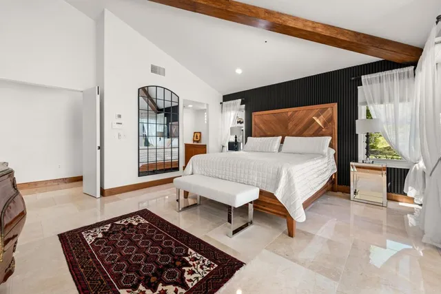 a bedroom with a bed and window