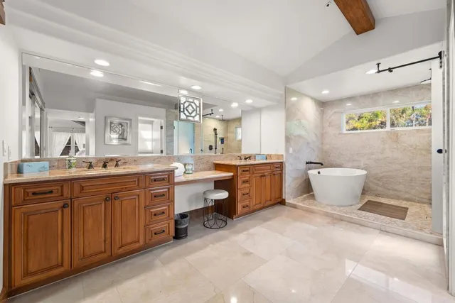a large bathroom with a large tub and sink