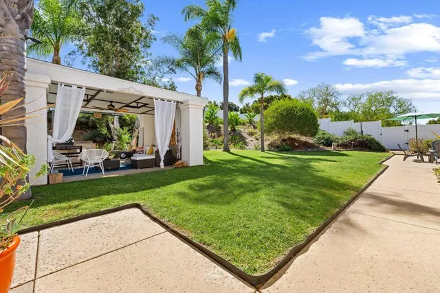 a view of a backyard with plants and a patio