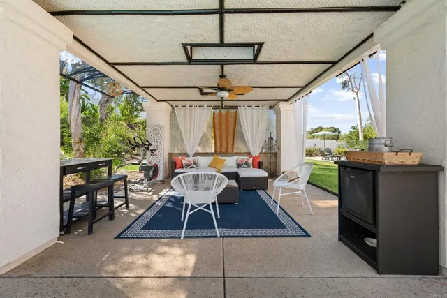 a dining room with furniture a rug and a chandelier