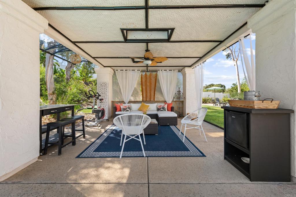 3427 Bumann Road Encinitas, CA 92024 - Photo 28 of 37 a dining room with furniture a rug and a chandelier