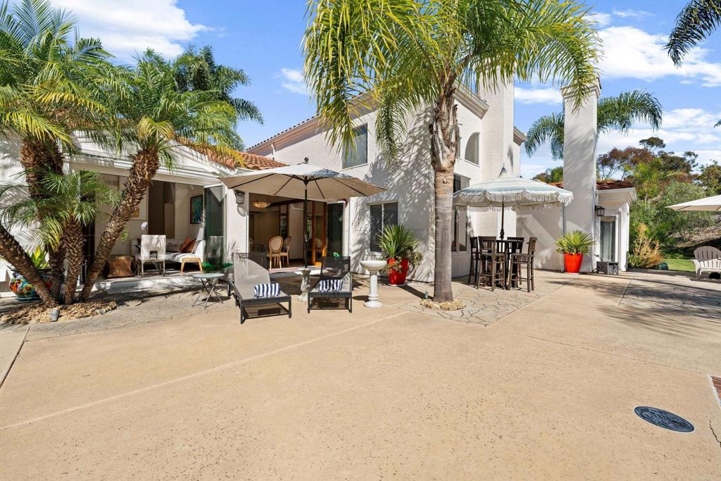 3427 Bumann Road Encinitas, CA 92024 - Photo 30 of 37 a view of a patio with a table and chairs under an umbrella