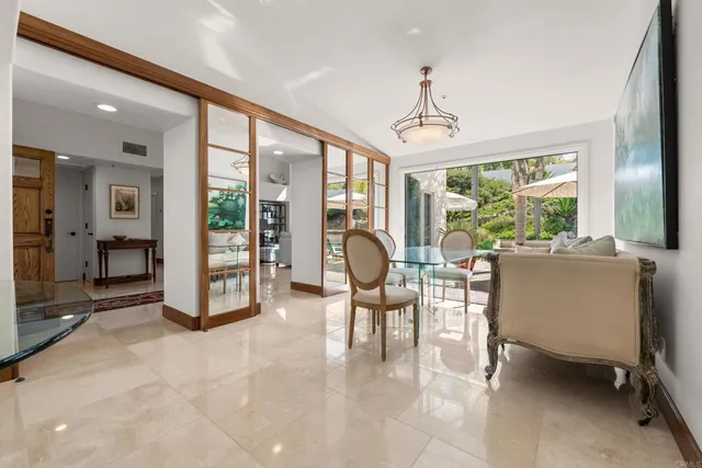 a living room with furniture a floor to ceiling window and floor to ceiling window