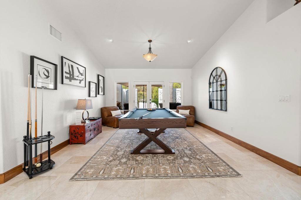 3427 Bumann Road Encinitas, CA 92024 - Photo 33 of 37 a living room with furniture a rug and wall paintings
