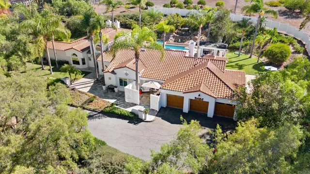 an aerial view of a house with a yard and garden