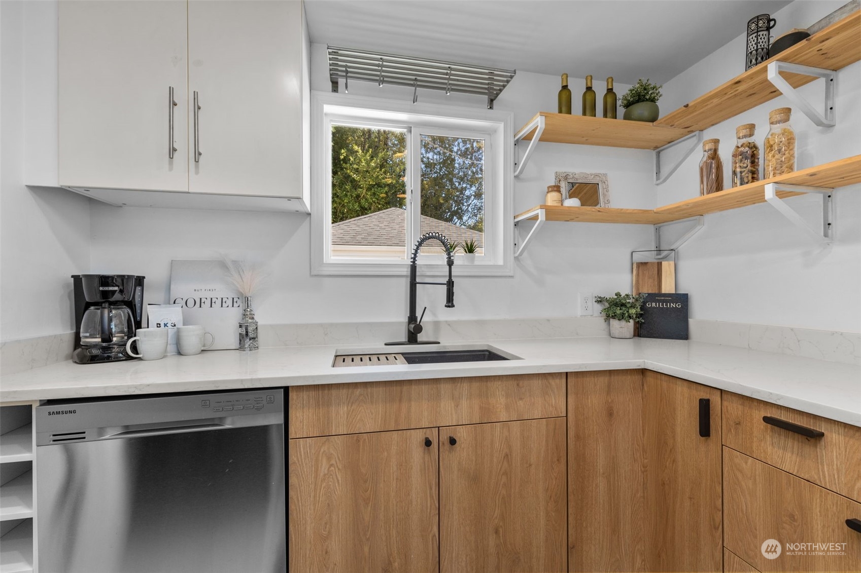 7911 18th Avenue Southwest Seattle, WA 98106 - Photo 11 of 32 a kitchen with stainless steel appliances granite countertop a sink dishwasher a refrigerator and cabinets with wooden floor