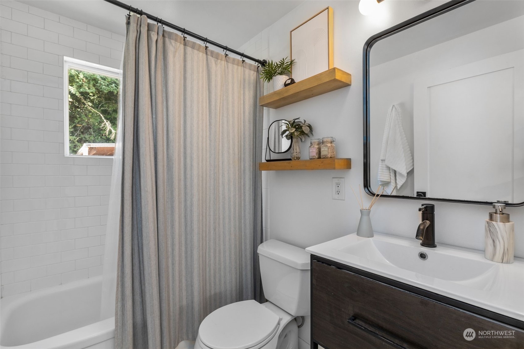 7911 18th Avenue Southwest Seattle, WA 98106 - Photo 18 of 32 a bathroom with a sink a toilet and shower curtain