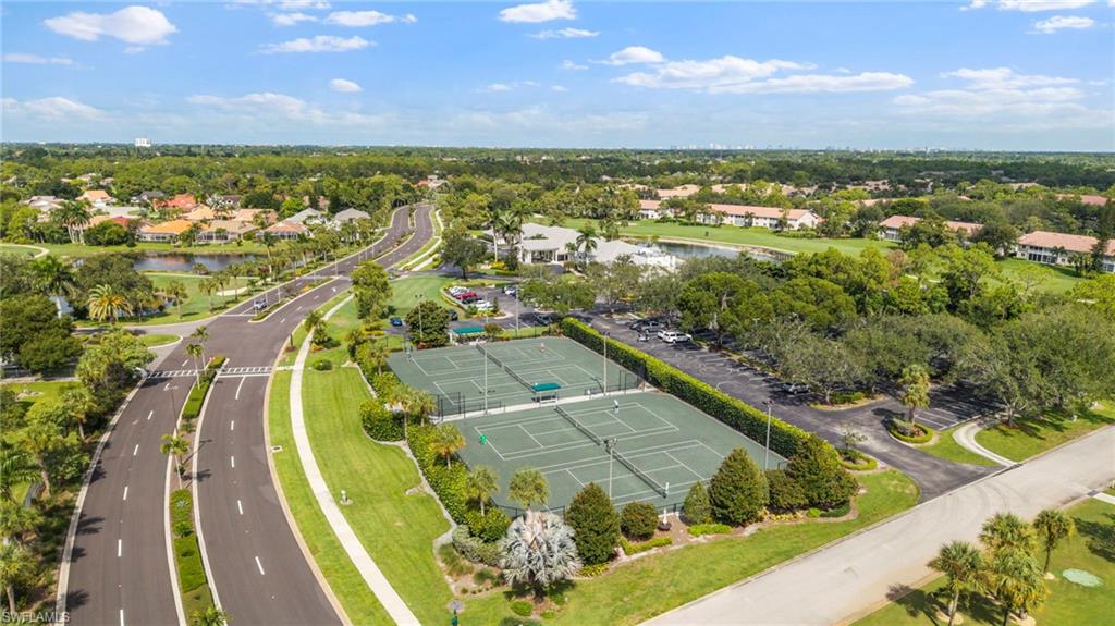 5801 Lago Villaggio Way Naples, FL 34104 - Photo 13 of 23 Aerial view of residential area with a nearby body of water