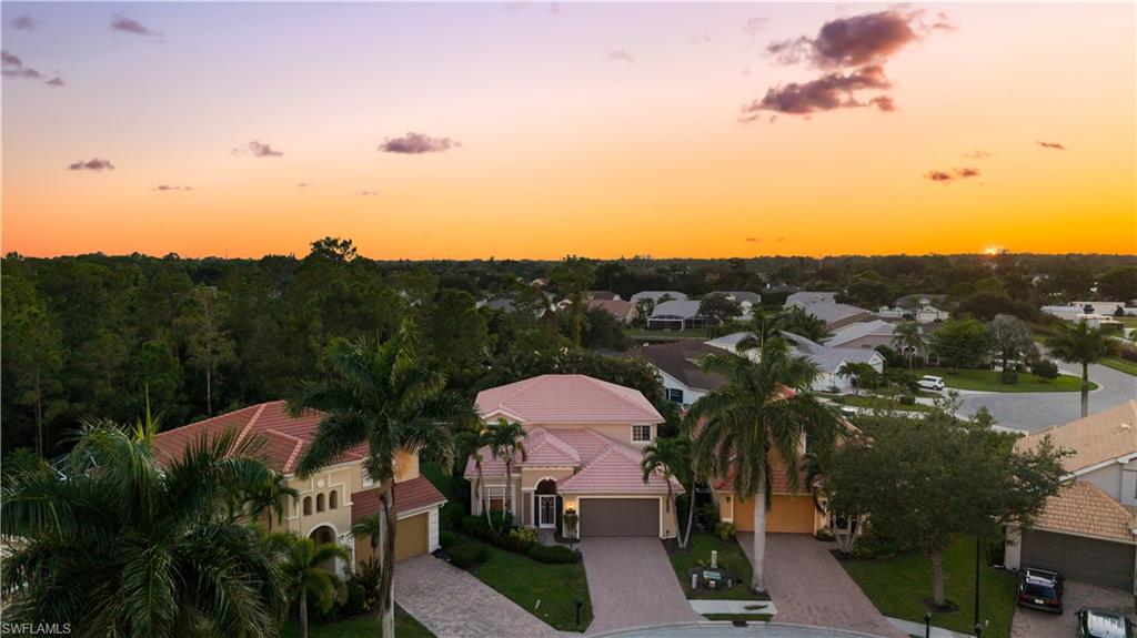5801 Lago Villaggio Way Naples, FL 34104 - Photo 20 of 23 Aerial view at dusk of a residential view