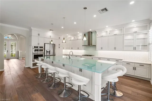 a large kitchen with a table and chairs in it