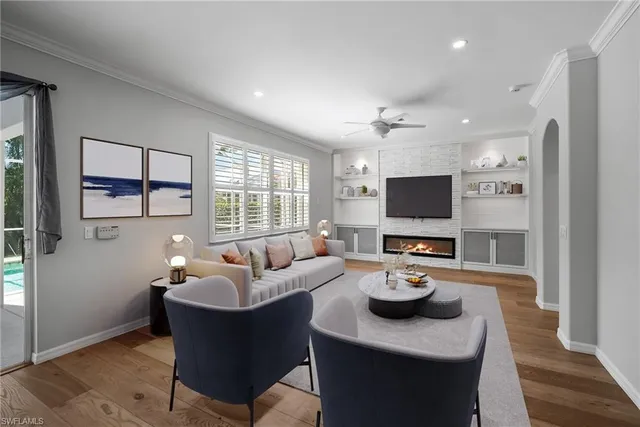a living room with furniture a window and a flat screen tv