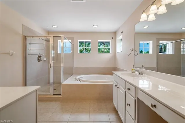a bathroom with a sink a large mirror and a bathtub