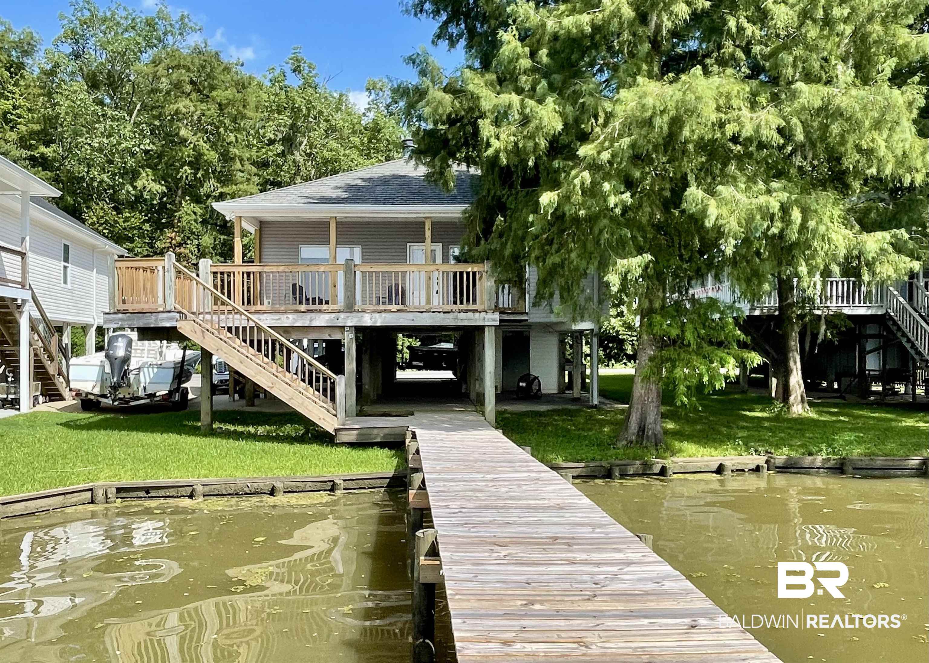 42119 Bayou Road Bay Minette, AL 36507 - Photo 1 of 51 Dock area featuring a yard and a deck with water view
