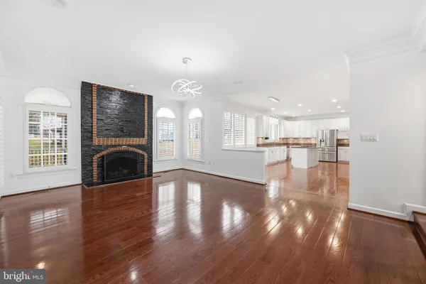 a view of a hallway with wooden floor and a fireplace