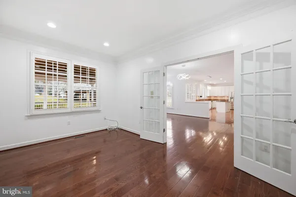 a view of a living room with hardwood floor and a window