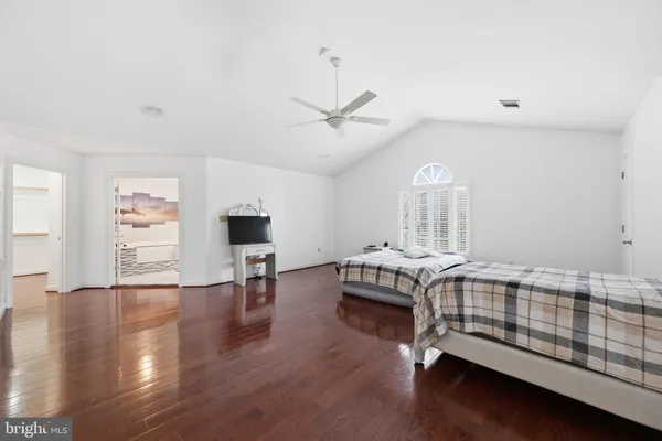 a bedroom with furniture and wooden floor
