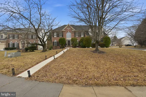 a pathway of a house with snow on the road
