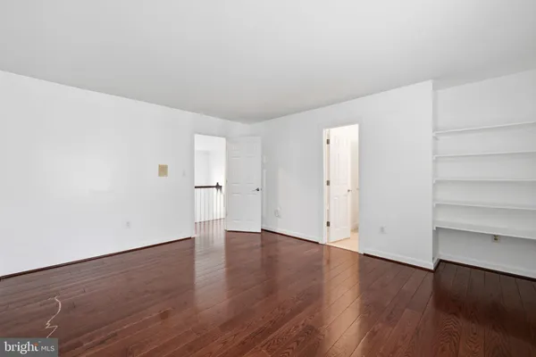 an empty room with wooden floor