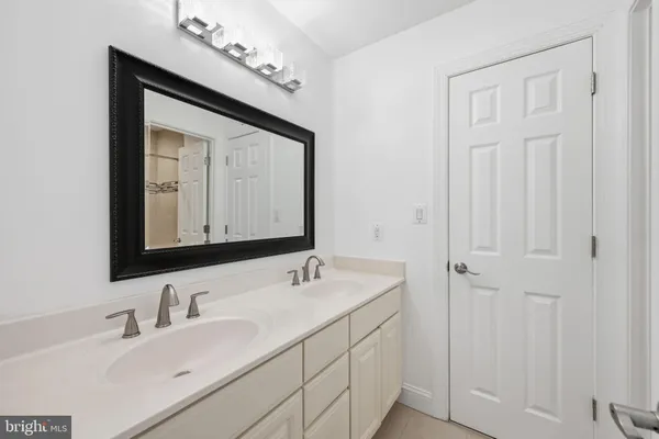 a bathroom with a double vanity sink and a mirror