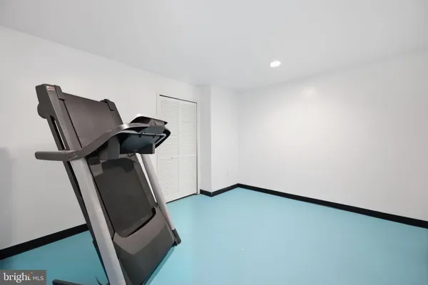 a view of a hallway with furniture and a floor to ceiling window