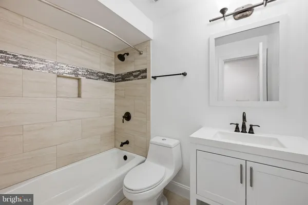 a bathroom with a toilet sink vanity shower and bathtub