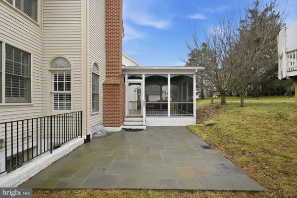 a view of a house with backyard outdoor seating and covered with trees