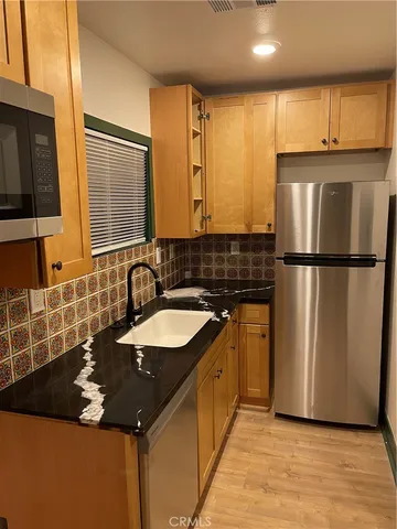 a kitchen with a sink and a refrigerator