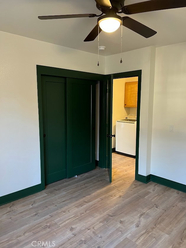 4061 Mission Inn Avenue Riverside, CA 92501 - Photo 5 of 9 an empty room with wooden floor closet fan and windows