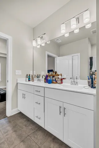 a bathroom with a sink vanity and mirror