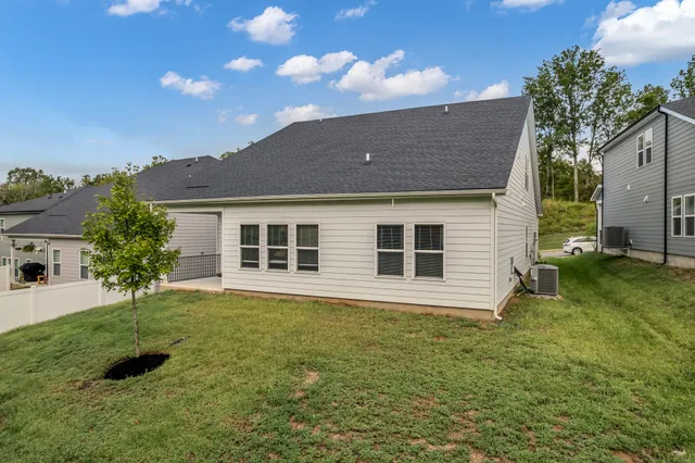 a front view of house with yard and trees