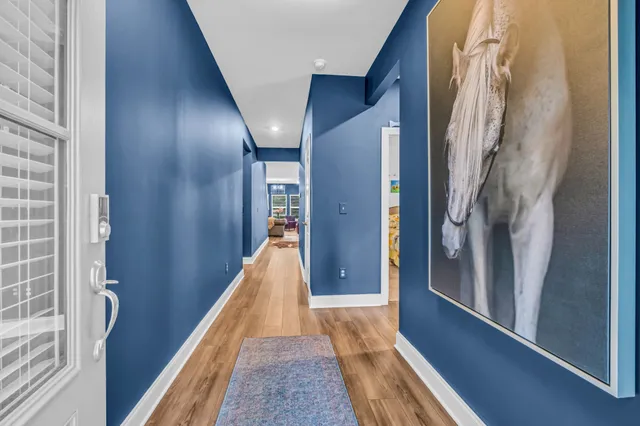 a view of hallway with stairs and wooden floor