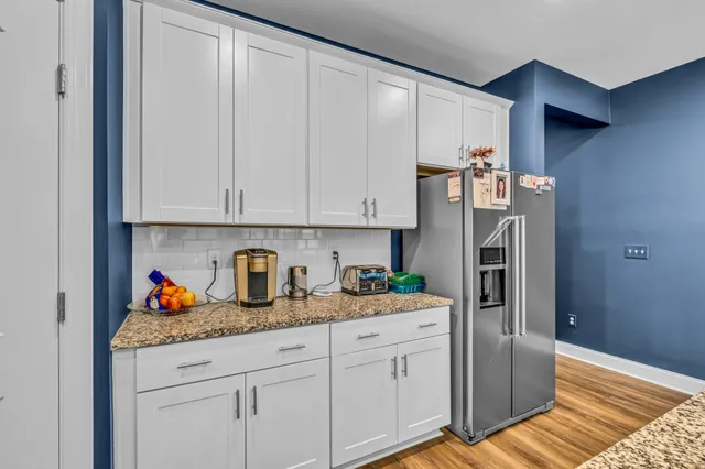 a kitchen with stainless steel appliances granite countertop a refrigerator sink and cabinets