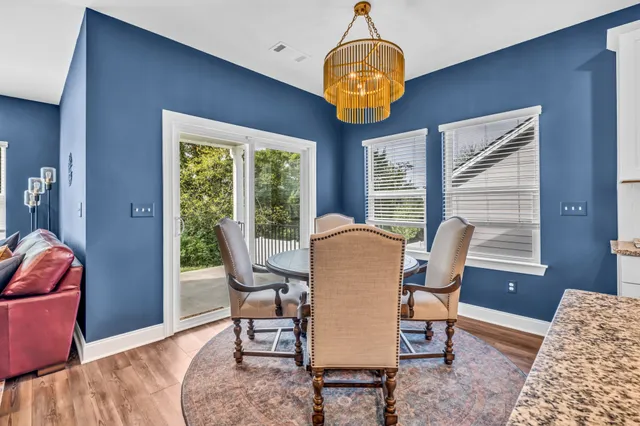 a view of a dining room with furniture wooden floor and chandelier