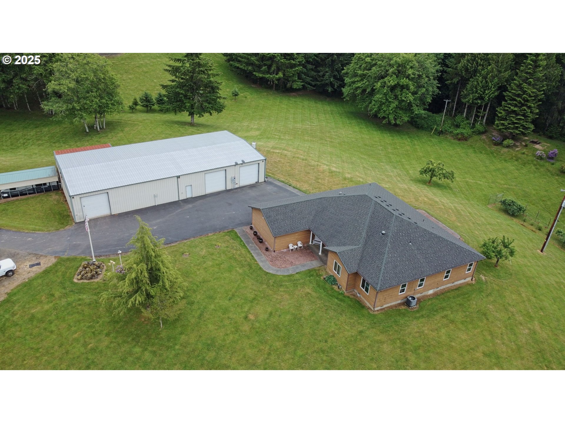 18229 Haven Acres Road Clatskanie, OR 97016 - Photo 1 of 45 a backyard of a house with a garden and outdoor seating