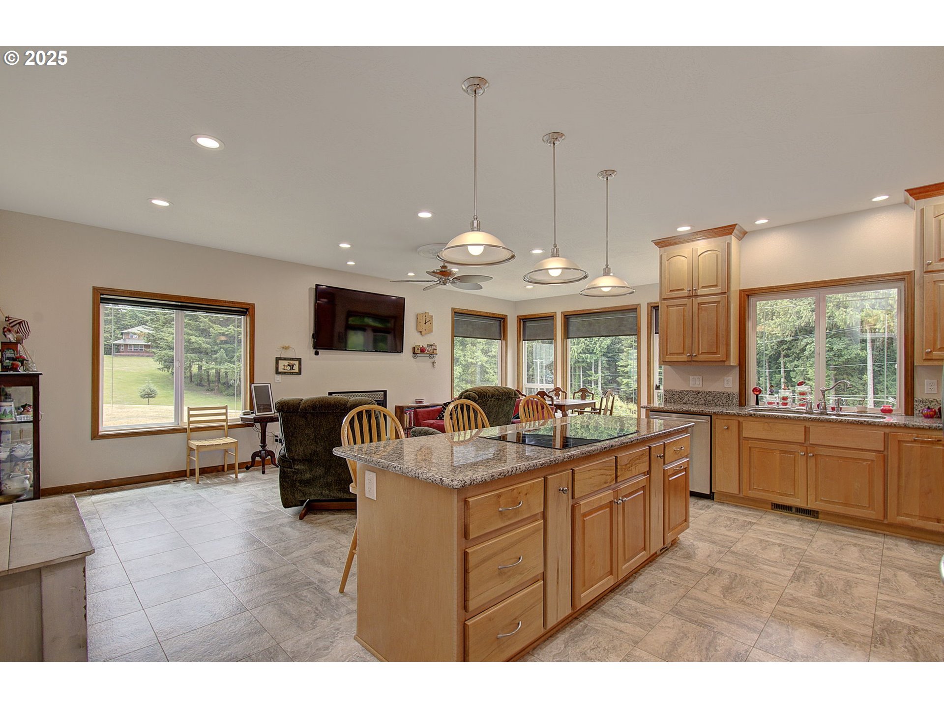 18229 Haven Acres Road Clatskanie, OR 97016 - Photo 18 of 45 a kitchen with kitchen island a large counter top space appliances and a living room view
