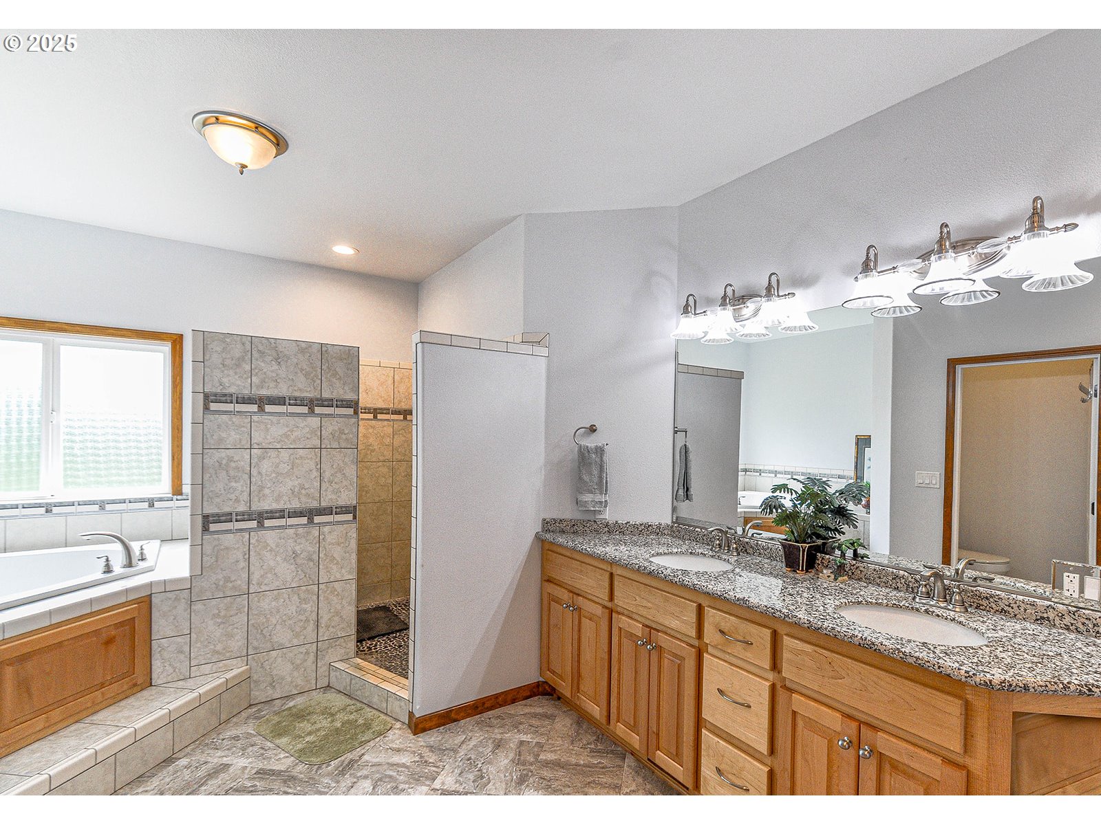 18229 Haven Acres Road Clatskanie, OR 97016 - Photo 27 of 45 a bathroom with a granite countertop double vanity sink a bathtub and shower