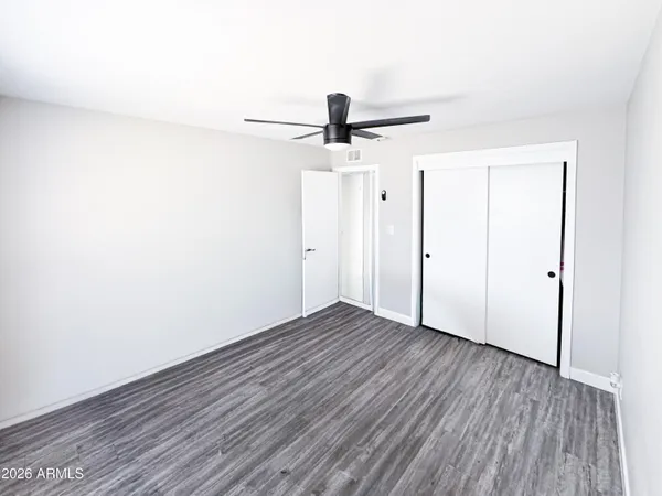 a view of a room with wooden floor