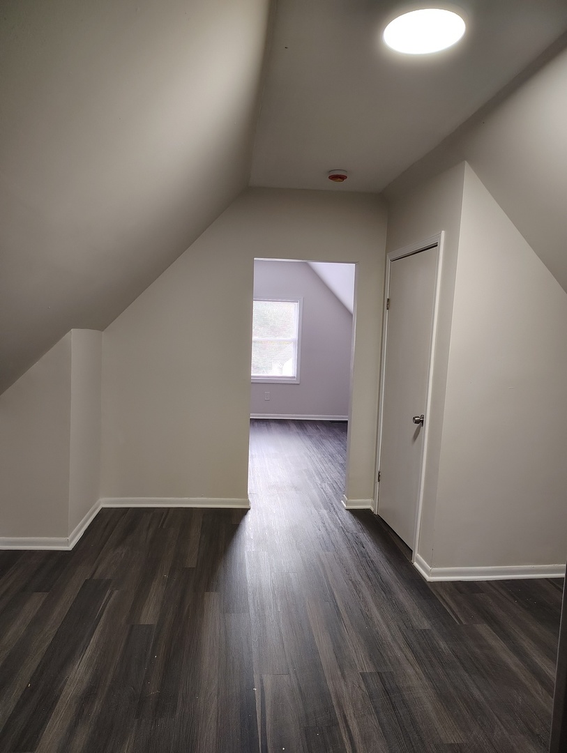 5740 South Elizabeth Street Chicago, IL 60636 - Photo 20 of 45 an empty room with wooden floor and windows
