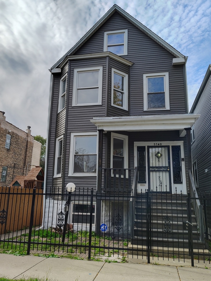 5740 South Elizabeth Street Chicago, IL 60636 - Photo 2 of 45 a front view of a house with a iron fence